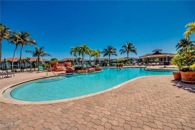 pool with a gazebo and a patio area