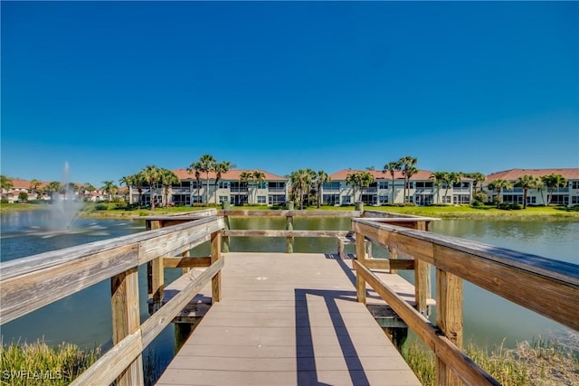 view of dock featuring a water view and a residential view