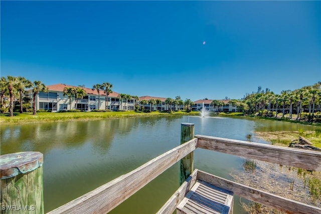 dock area featuring a residential view and a water view