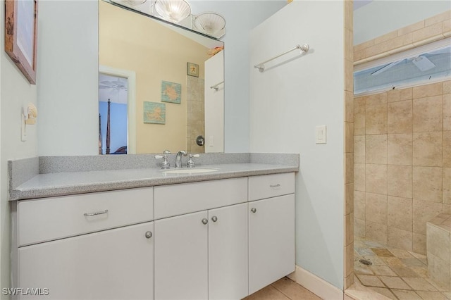 full bath with vanity, tile patterned floors, and tiled shower