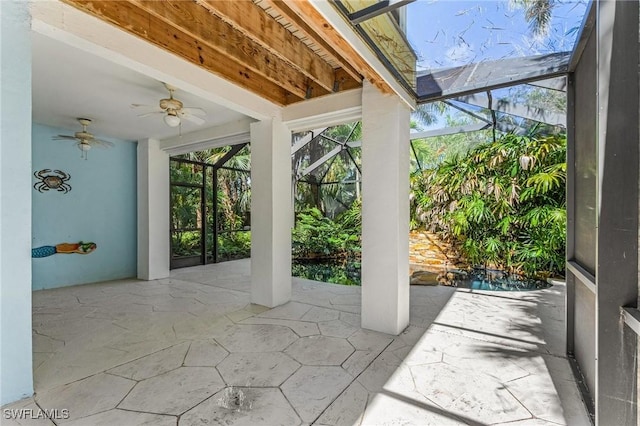 view of patio / terrace with glass enclosure and a ceiling fan