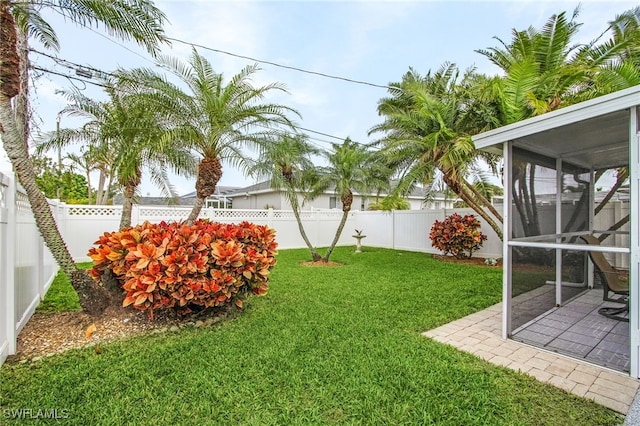 view of yard with a fenced backyard and a sunroom