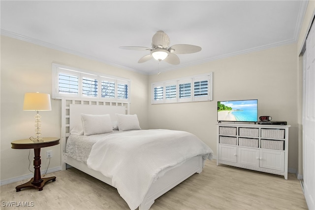 bedroom featuring light wood-style flooring, baseboards, and ornamental molding