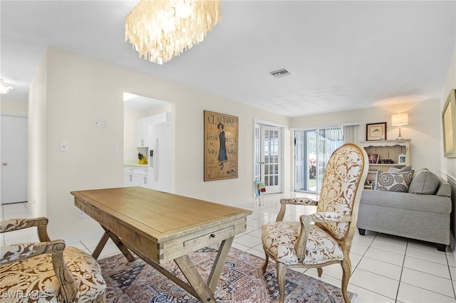 interior space featuring a notable chandelier, light tile patterned floors, and visible vents