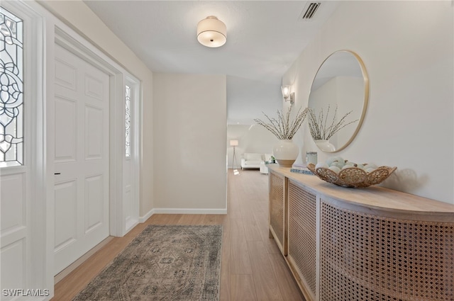 entryway featuring a wealth of natural light, visible vents, baseboards, and light wood-style flooring