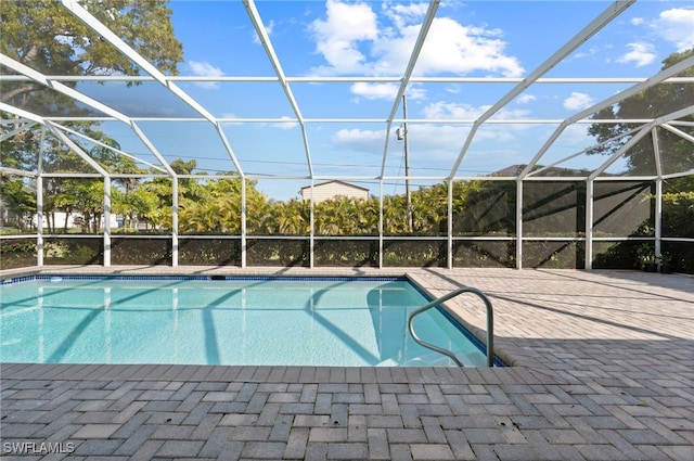 outdoor pool with a lanai and a patio