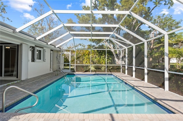 outdoor pool featuring a lanai and a patio area