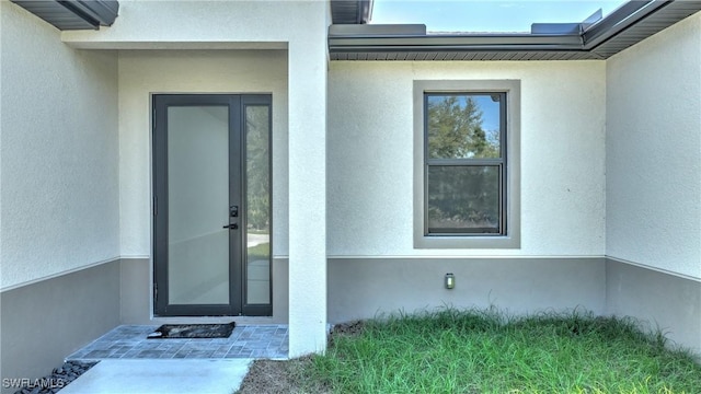 doorway to property with stucco siding