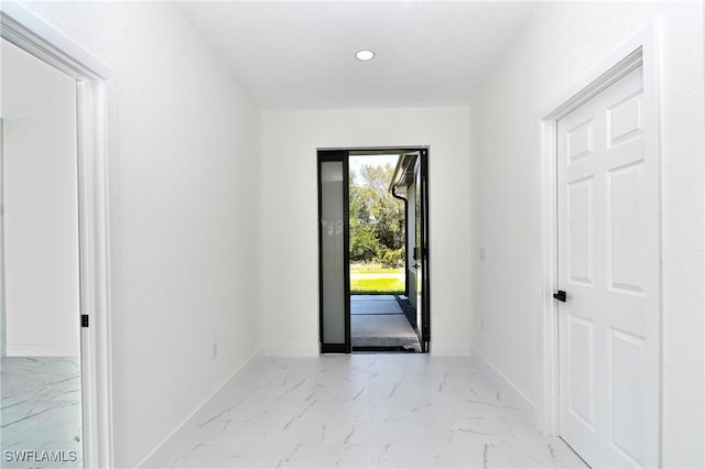 interior space featuring recessed lighting, baseboards, and marble finish floor