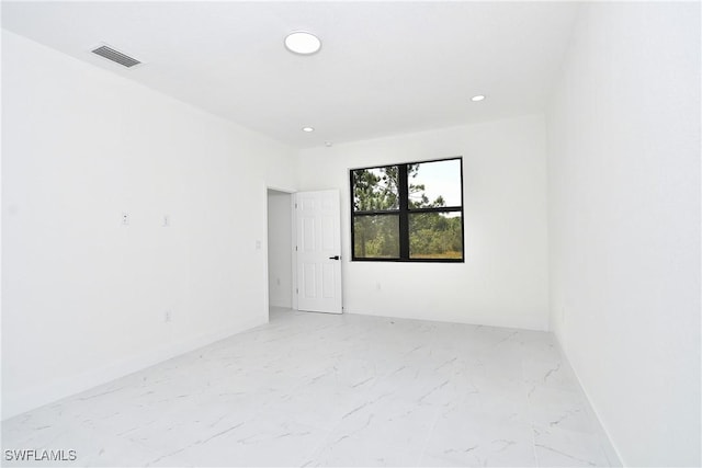 spare room featuring recessed lighting, visible vents, marble finish floor, and baseboards