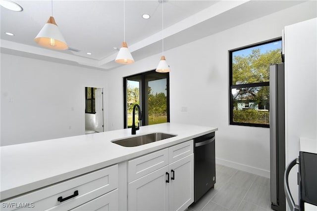 2810 64th St W, Lehigh Acres, FL 33971 - kitchen featuring a tray ceiling, light countertops, a sink, dishwasher, and decorative light fixtures