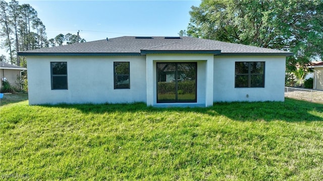 2810 64th St W, Lehigh Acres, FL 33971 - back of property with a lawn, fence, roof with shingles, and stucco siding