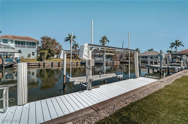 view of dock featuring boat lift and a water view