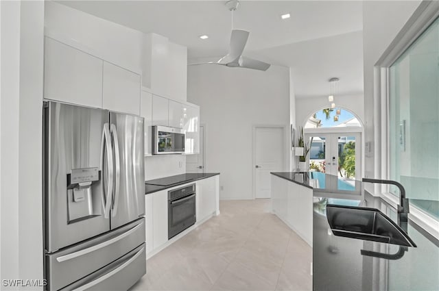 kitchen featuring black appliances, french doors, white cabinets, dark countertops, and modern cabinets