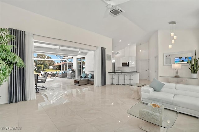 living area with light marble finish flooring and high vaulted ceiling