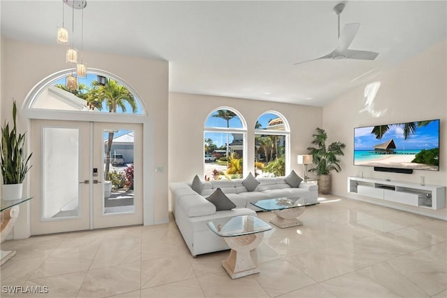living room featuring french doors, ceiling fan, and a chandelier