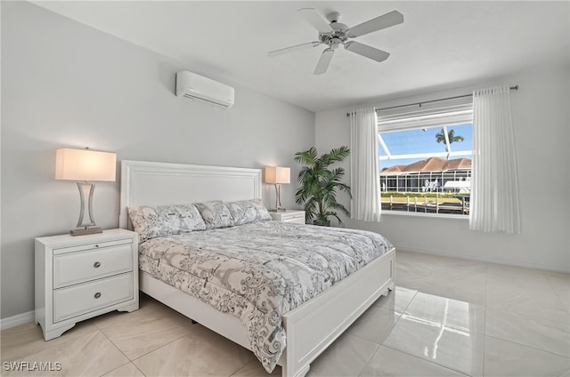 bedroom with a wall mounted air conditioner, baseboards, and a ceiling fan