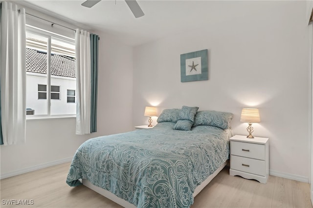 bedroom with wood finished floors, baseboards, and ceiling fan