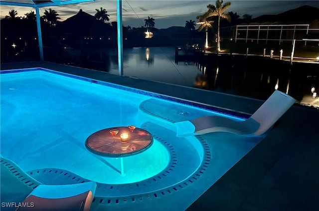 outdoor pool featuring a lanai and a water view
