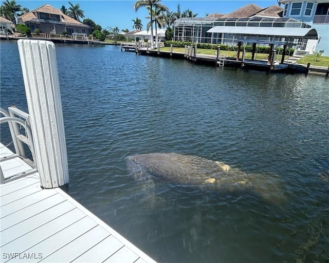 dock area with a water view and a residential view