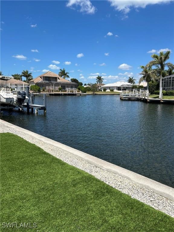 dock area featuring a yard and a water view