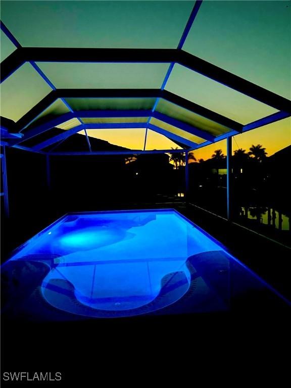 exterior space with glass enclosure and a patio
