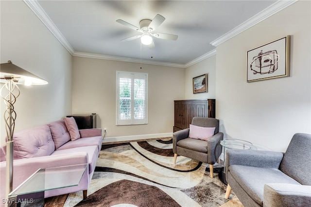 living area featuring baseboards, ornamental molding, and a ceiling fan