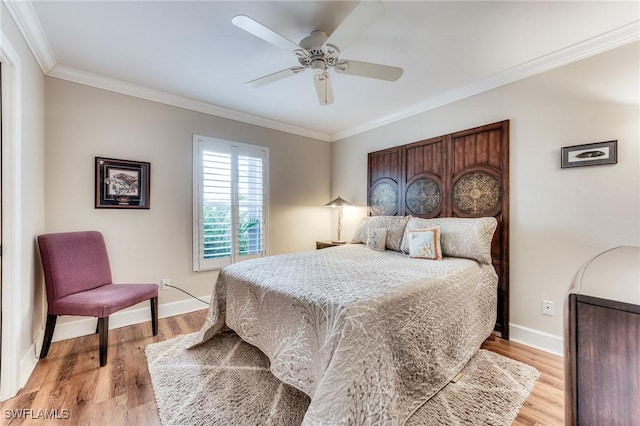 bedroom with crown molding, light wood-style flooring, and baseboards