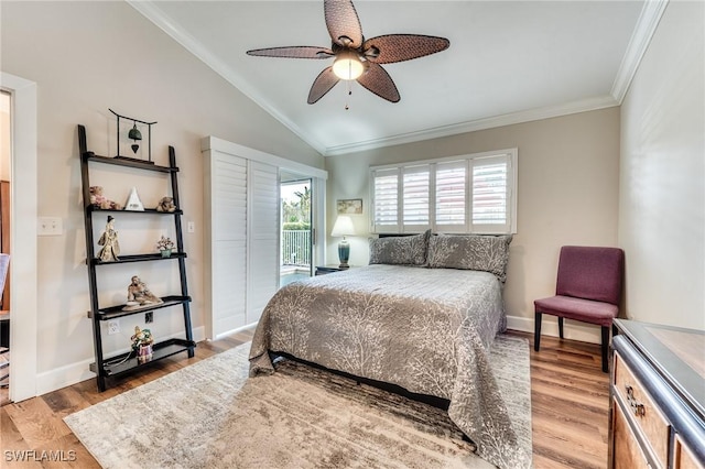 bedroom featuring vaulted ceiling, wood finished floors, and ornamental molding