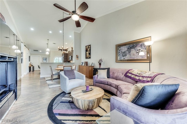 living room featuring high vaulted ceiling, ceiling fan with notable chandelier, light wood finished floors, and ornamental molding