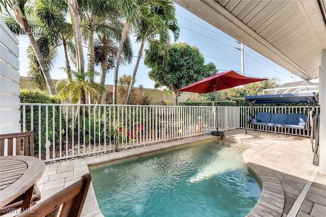 view of swimming pool with a patio and fence