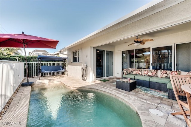 view of swimming pool featuring a patio area, an outdoor hangout area, a ceiling fan, and fence