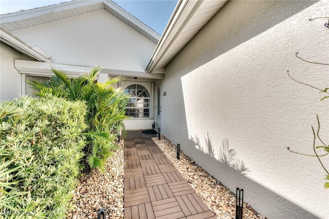 view of side of home with stucco siding