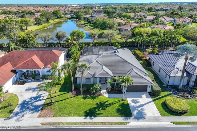 drone / aerial view with a residential view and a water view