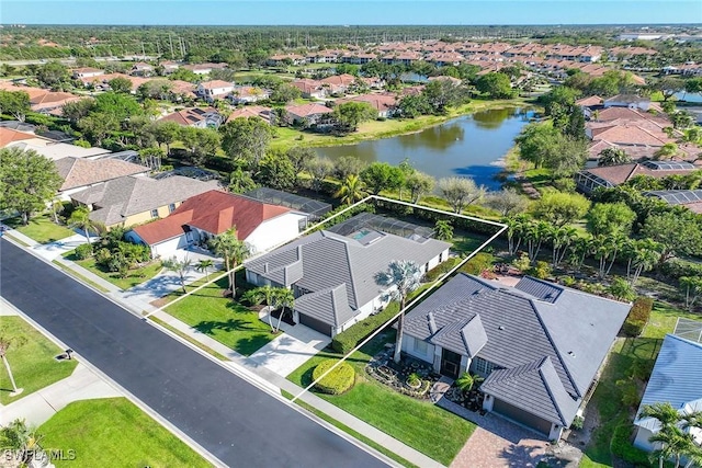 birds eye view of property with a residential view and a water view