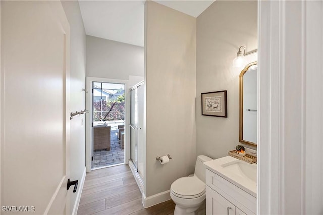 full bath with vanity, a shower stall, toilet, and wood finished floors