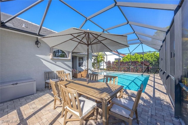 outdoor pool with outdoor dining area, a lanai, and a patio area