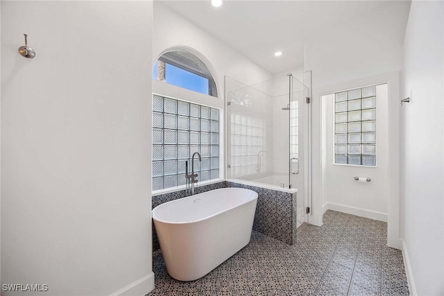 full bathroom with a soaking tub, an enclosed shower, recessed lighting, and baseboards