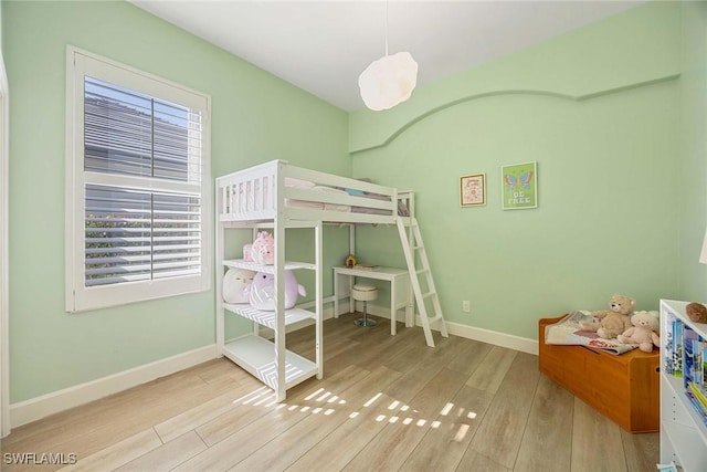 unfurnished bedroom featuring baseboards and wood finished floors