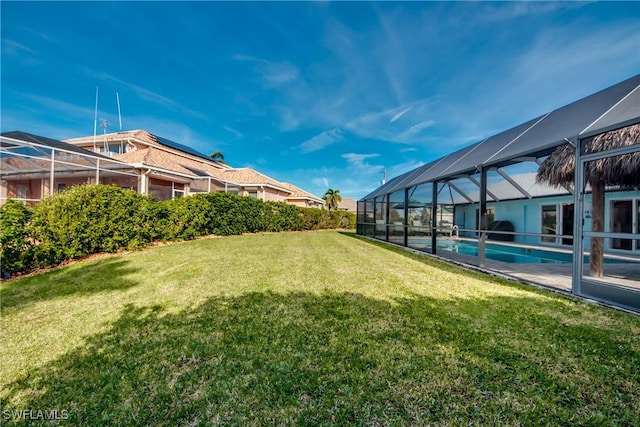 view of yard featuring an outdoor pool and a lanai