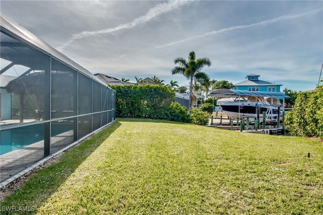 view of yard featuring a lanai, boat lift, an outdoor pool, and a boat dock