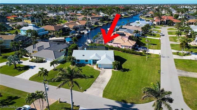 drone / aerial view featuring a residential view and a water view