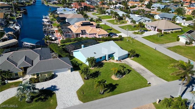 drone / aerial view featuring a residential view and a water view