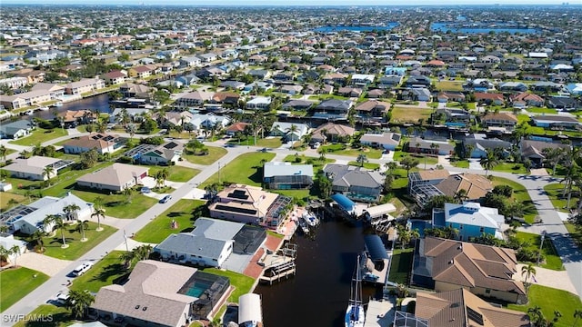 birds eye view of property with a residential view and a water view