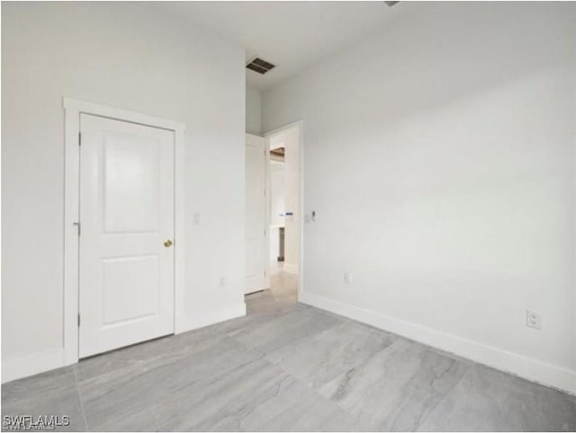 unfurnished bedroom featuring visible vents and baseboards