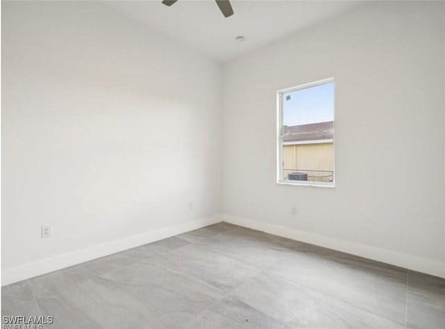 unfurnished room featuring a ceiling fan and baseboards