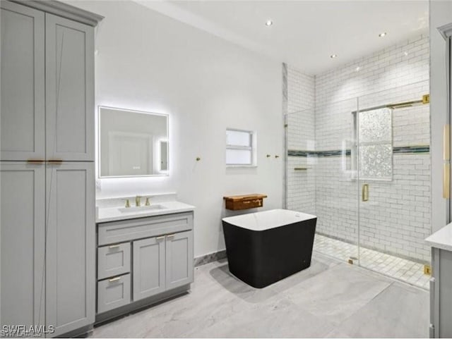 bathroom with vanity, a shower stall, and a freestanding bath