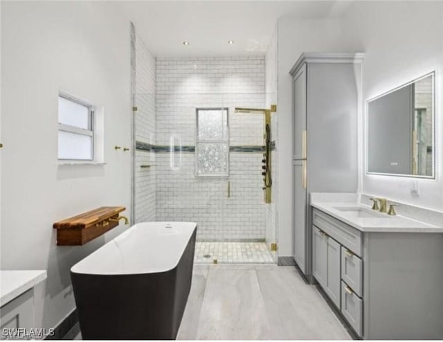 full bathroom with vanity, a shower stall, and a soaking tub