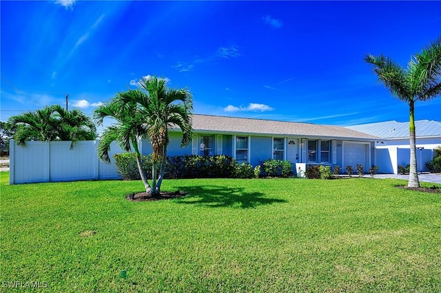 ranch-style house featuring a garage, a front lawn, and fence