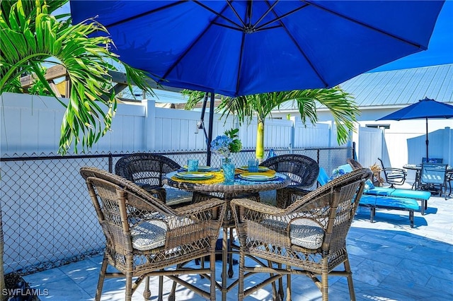 view of patio featuring outdoor dining space and fence